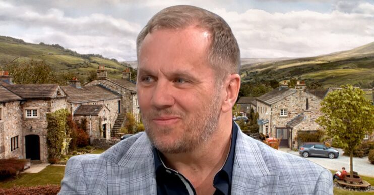 Dean Andrews in front of Emmerdale background