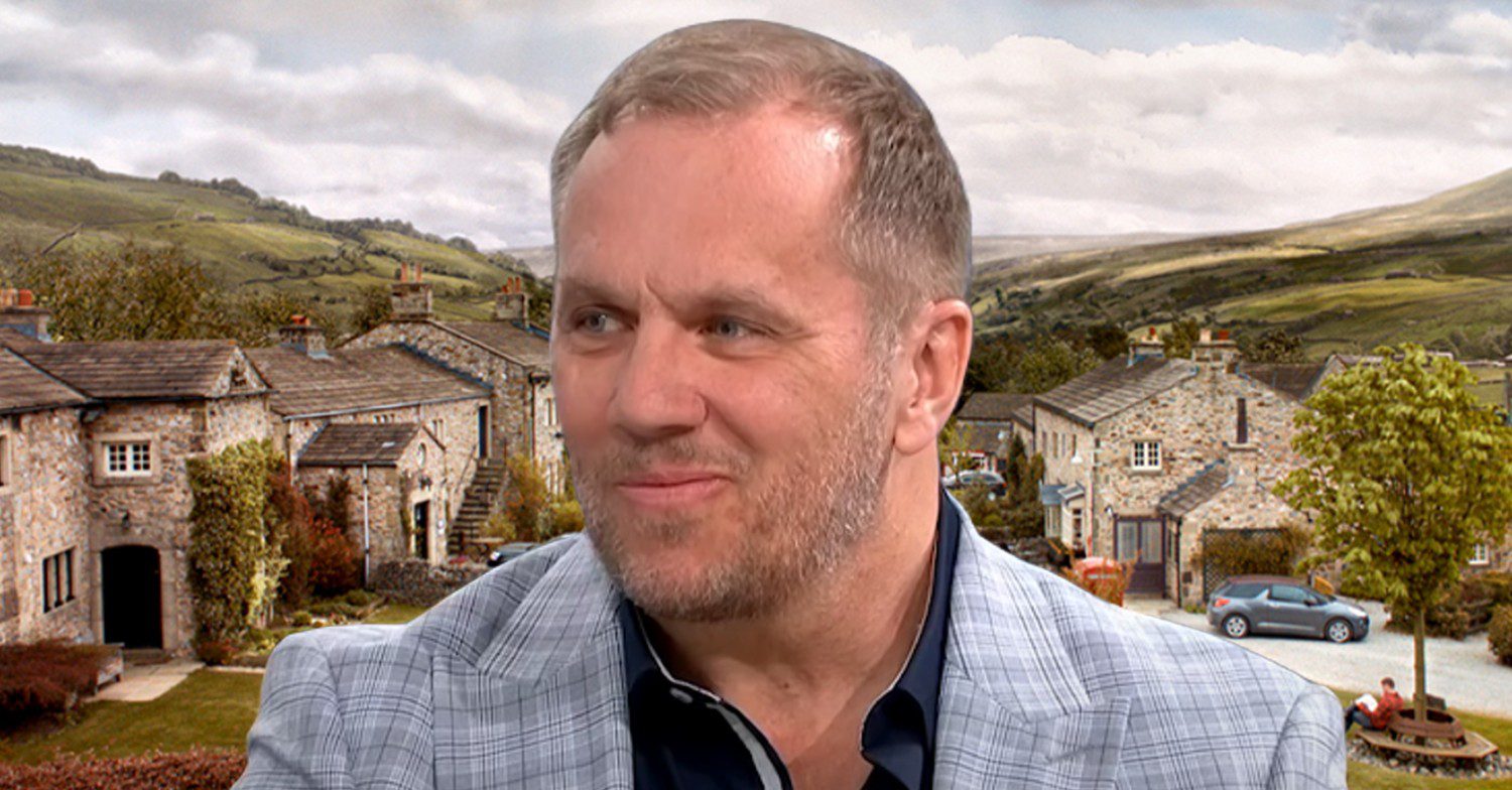 Dean Andrews in front of Emmerdale background