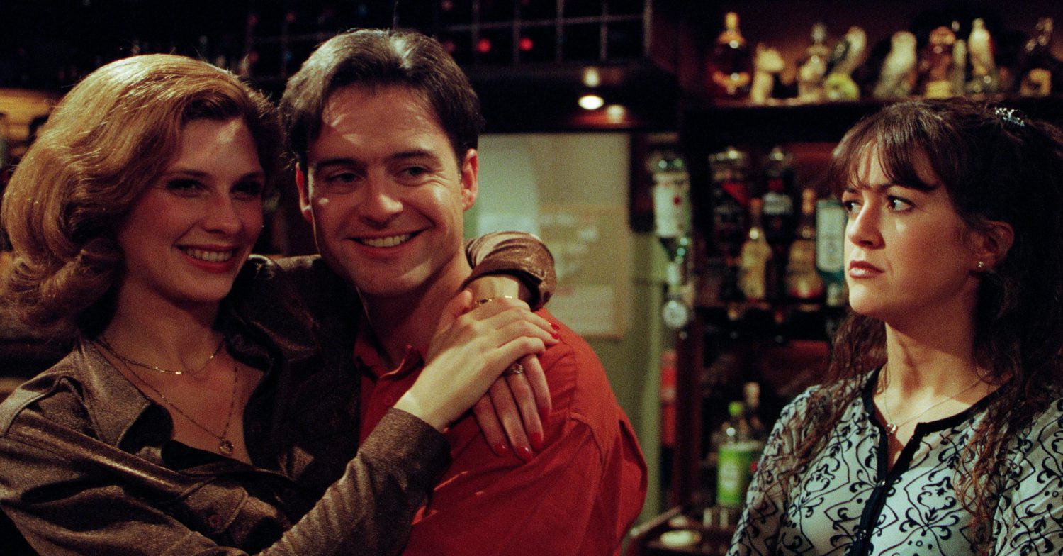 Emmerdale's Bernice and Gavin are hugging as Tricia looks on in the pub