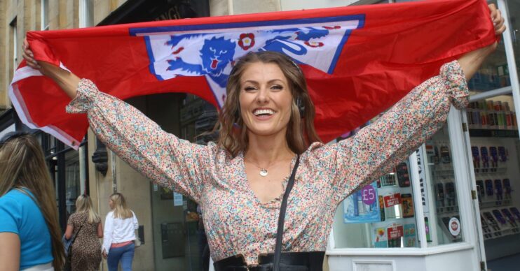 Football fan holding up England fan