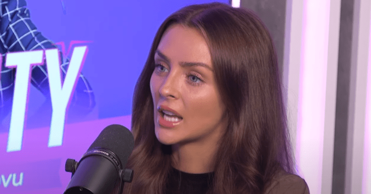 Kady McDermott speaking into a podcast mic