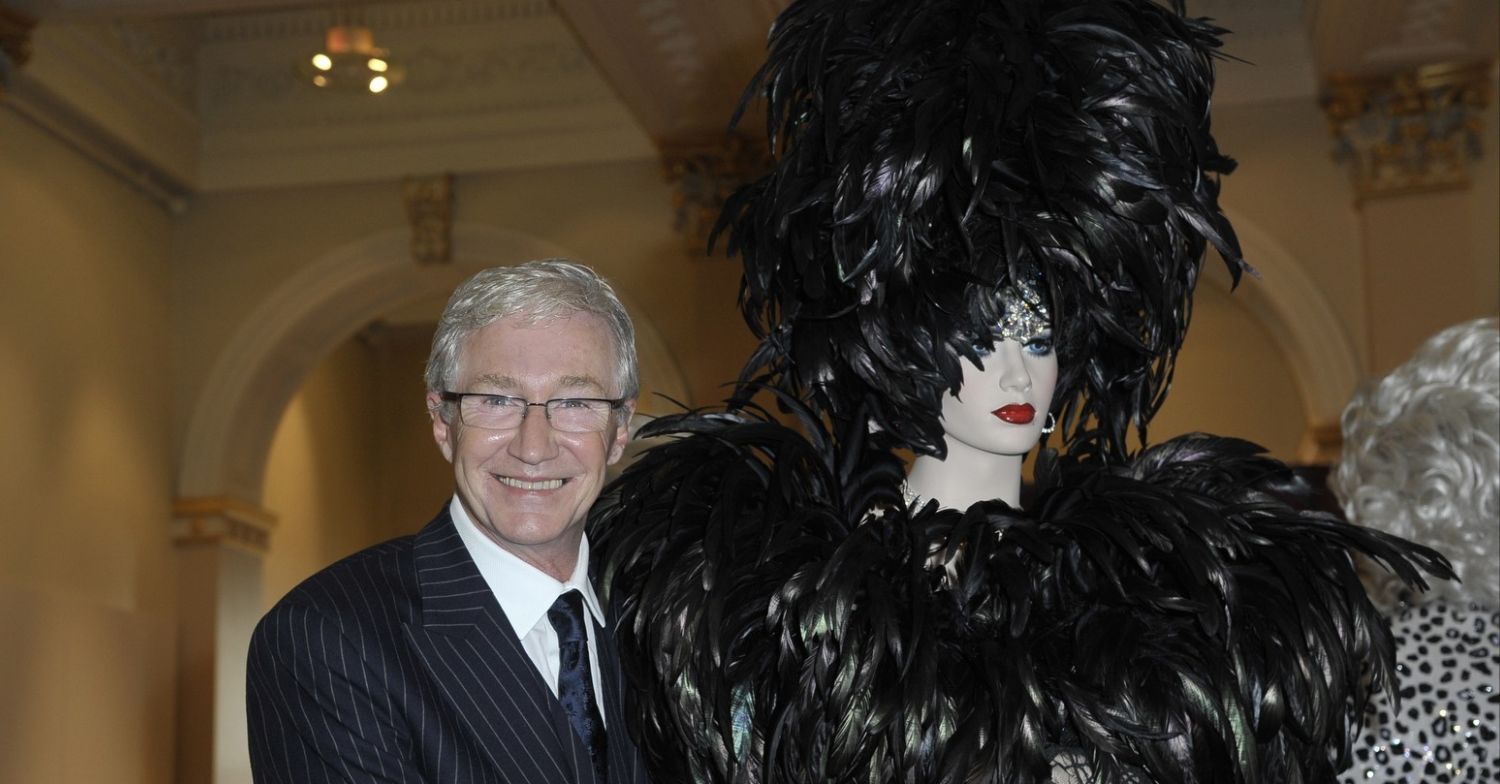 Paul O'Grady smiling next to mannequin. 