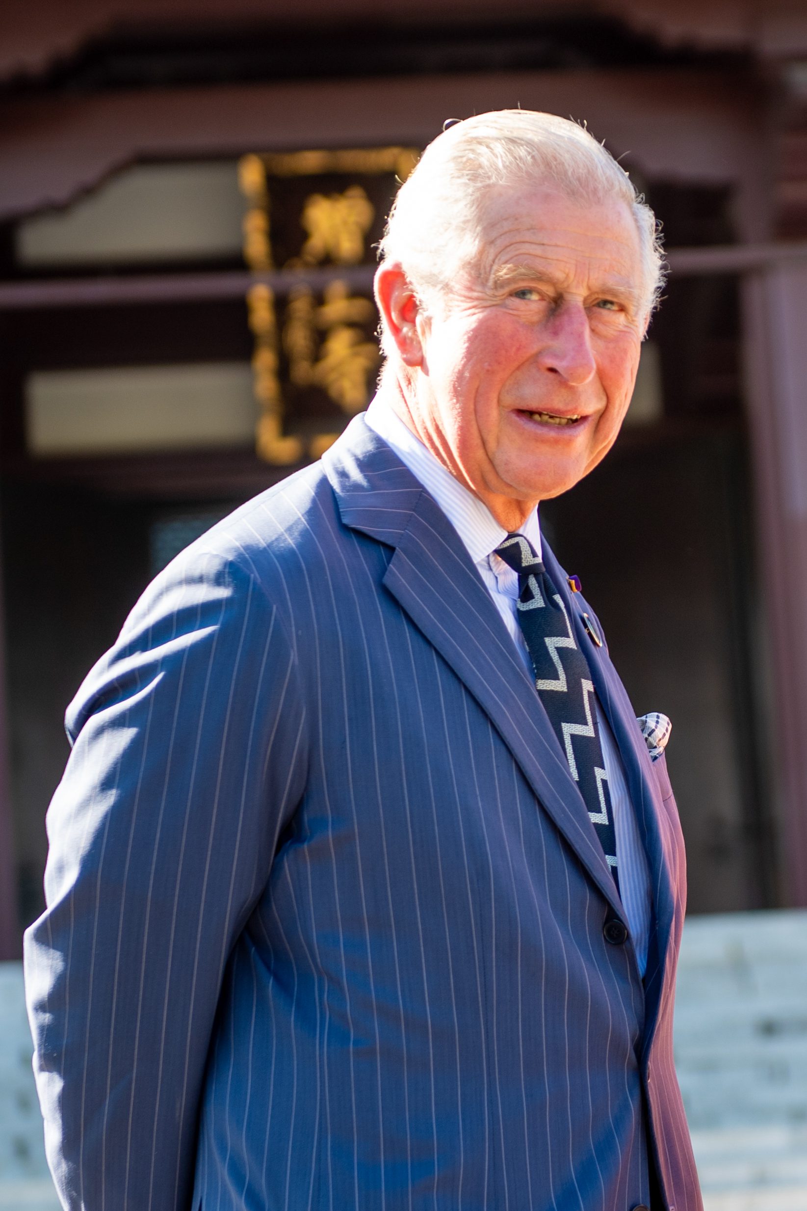 King Charles in the sunshine smiling in a blue suit