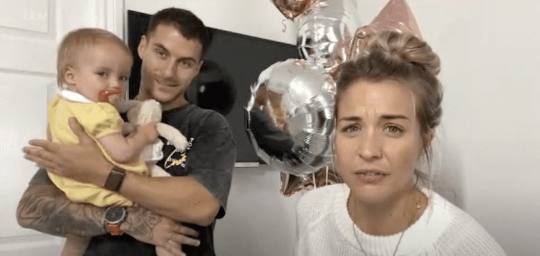 Gorka Marquez holding daughter Mia next to Gemma Atkinson, balloons in background