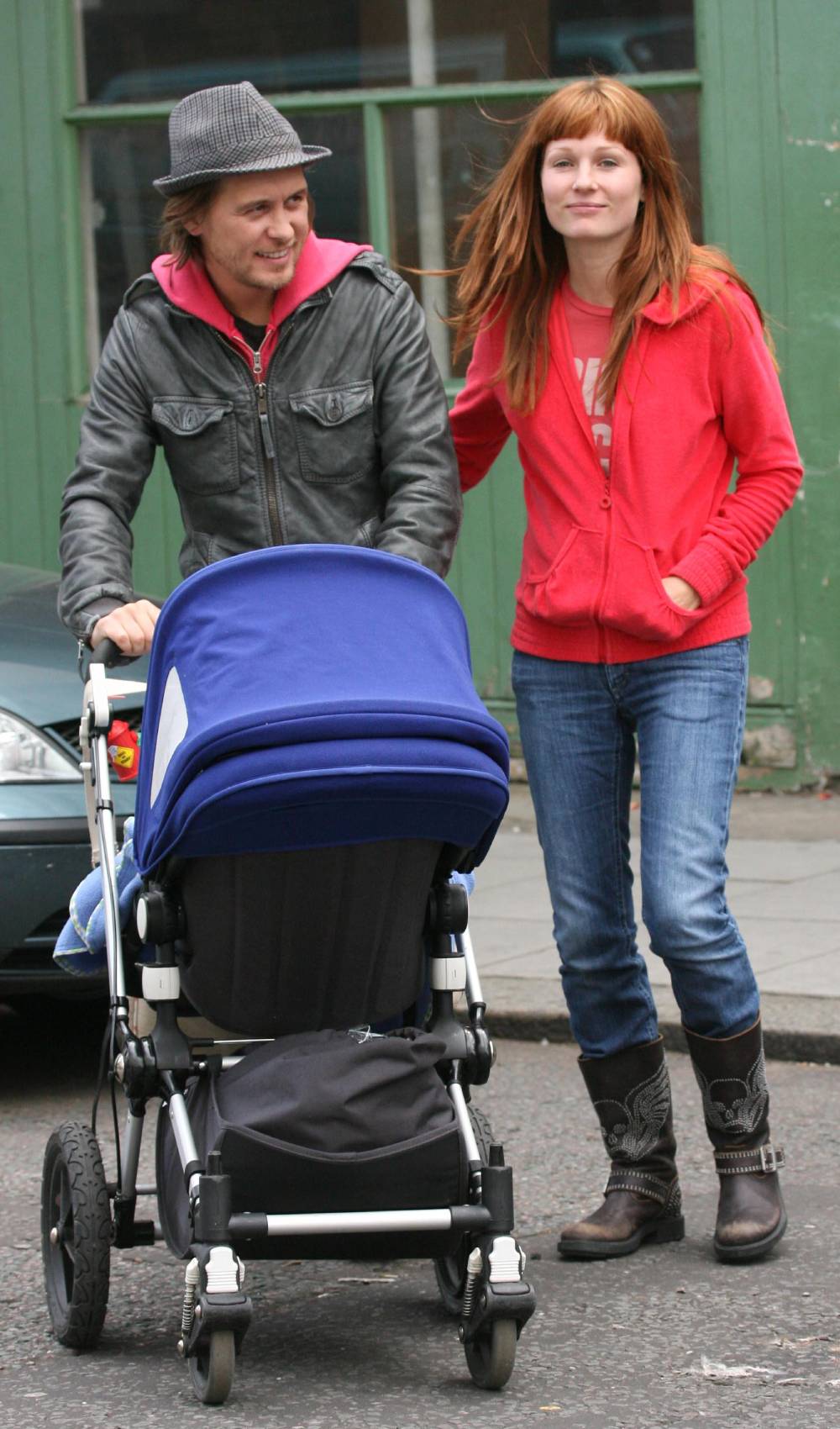Take That star Mark Owen pushes a wheelchair alongside wife Emma