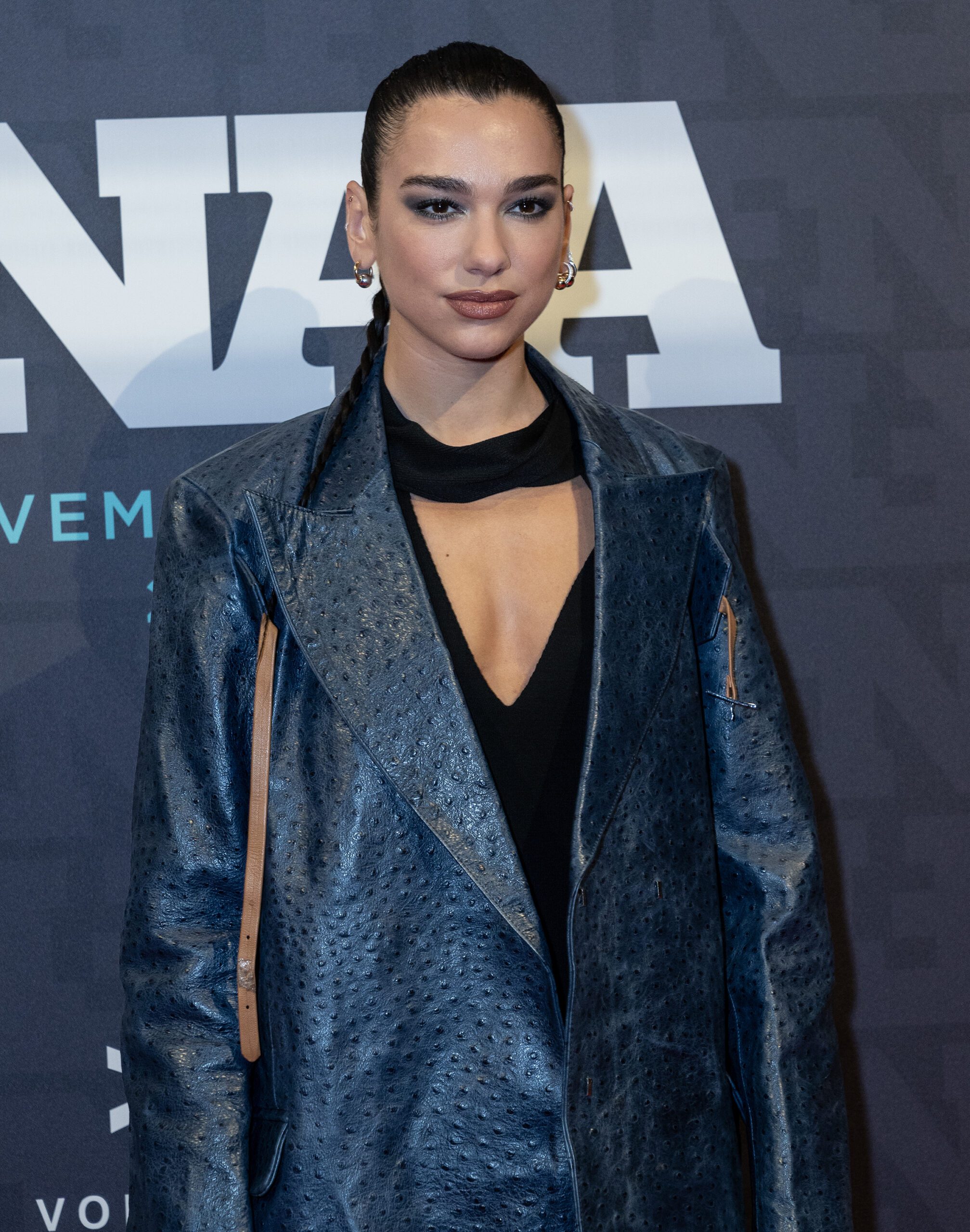 Dua Lipa with her hair tied back