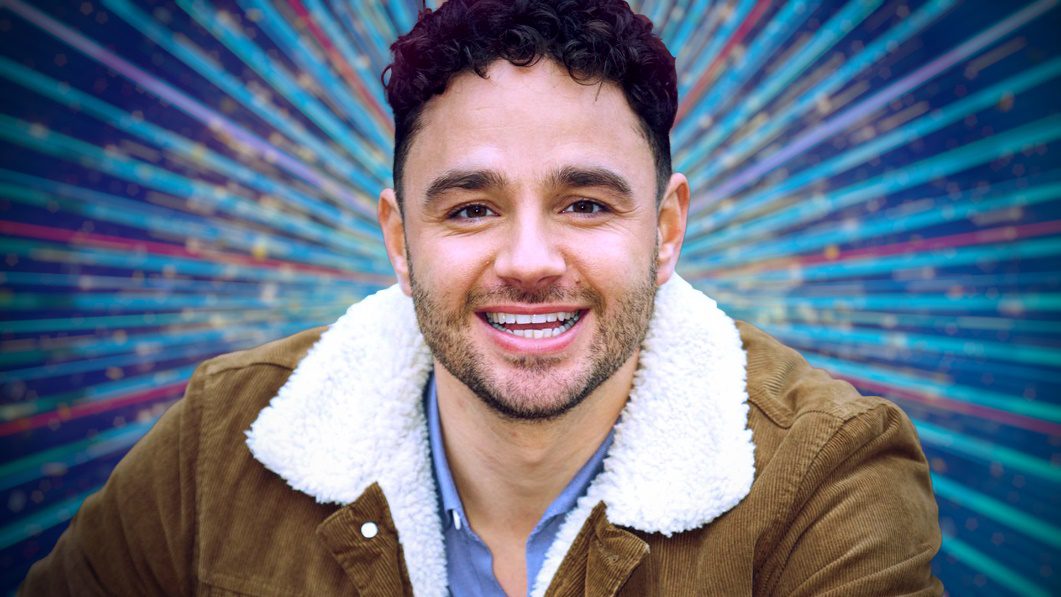 Adam Thomas against a Strictly background