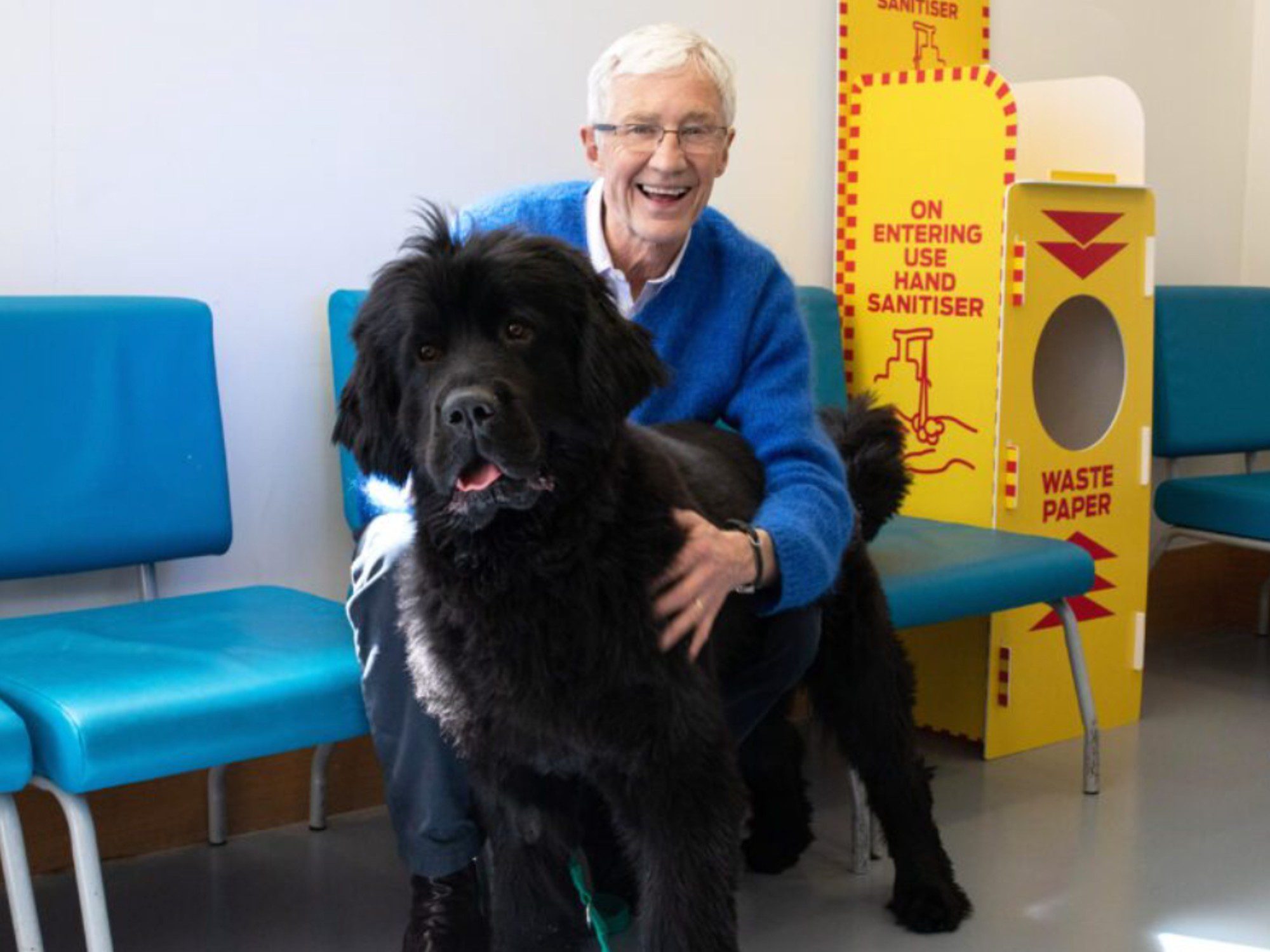 Paul O'Grady hugging a dog