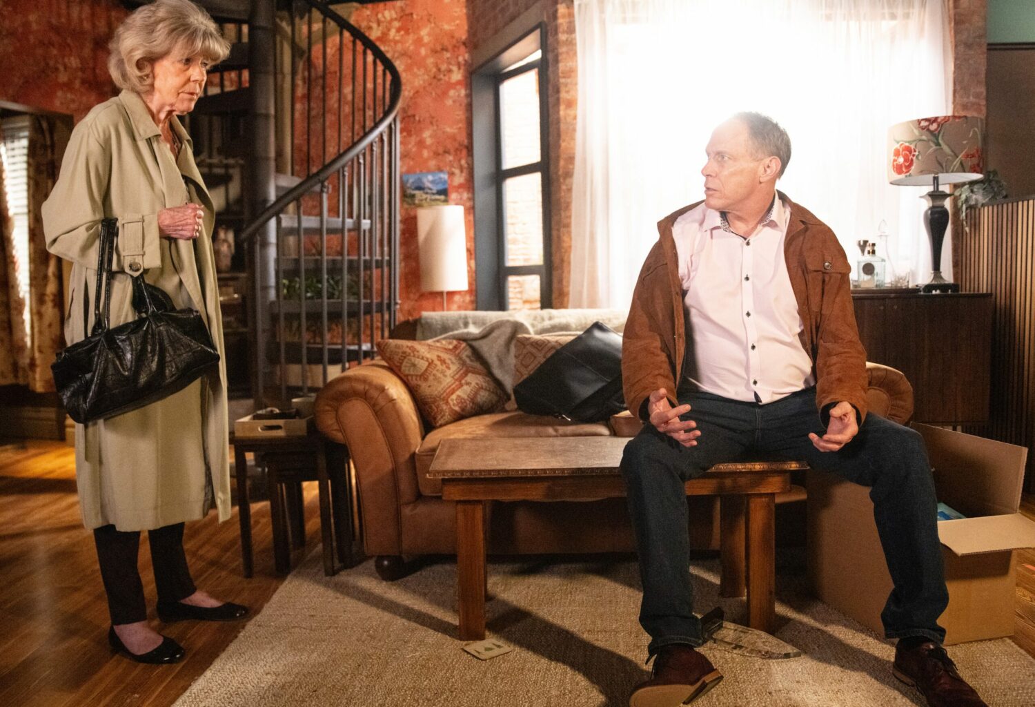 Audrey and Stephen chat in his flat 