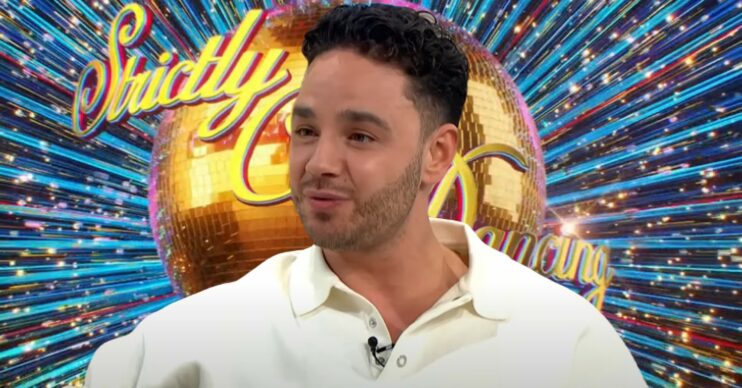 Adam Thomas in front of Strictly logo