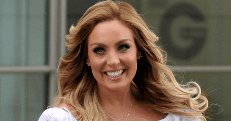 Amy Dowden smiling with her hair blowing in the wind