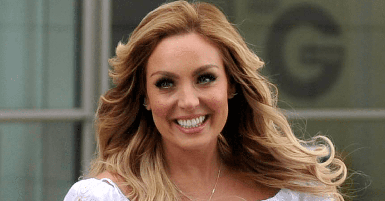 Amy Dowden smiling with her hair blowing in the wind