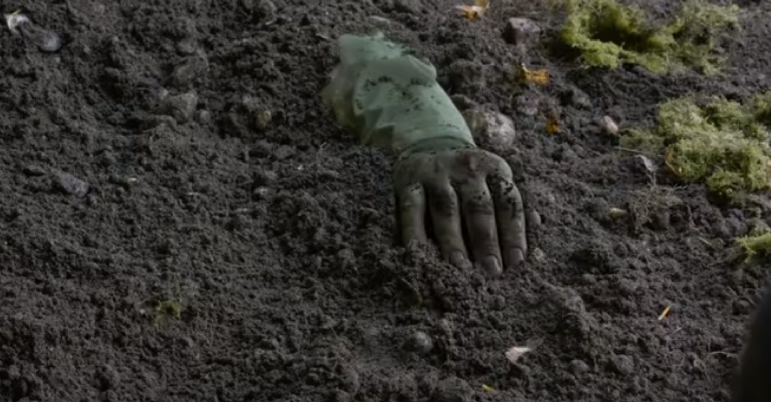Coronation Street's Leo's hand emerging from the earth