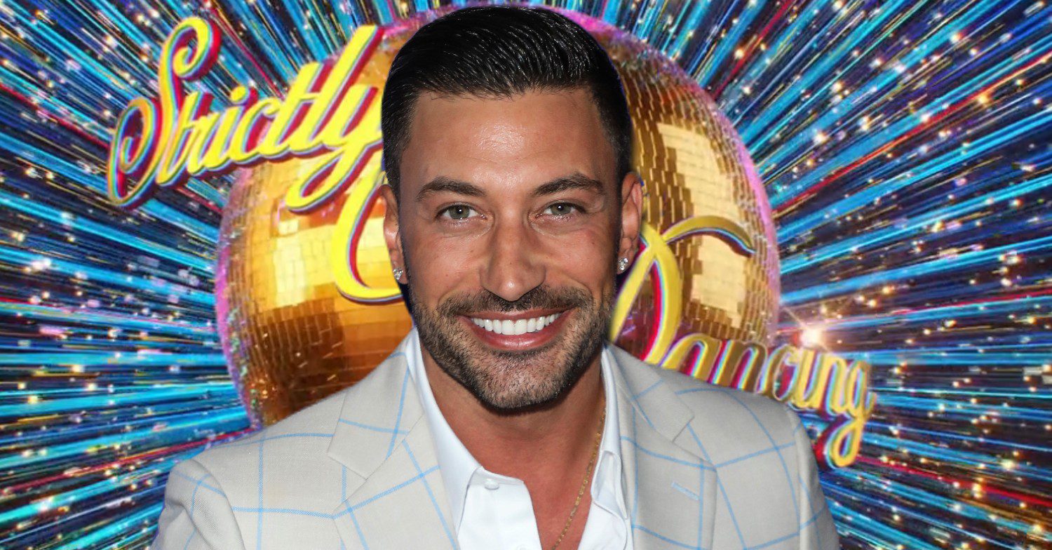 Giovanni Pernice smiling in front of Strictly logo