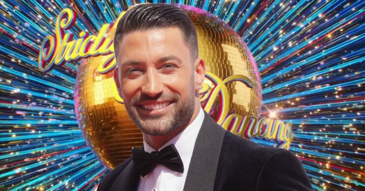 Giovanni Pernice smiling in tuxedo in front of Strictly logo