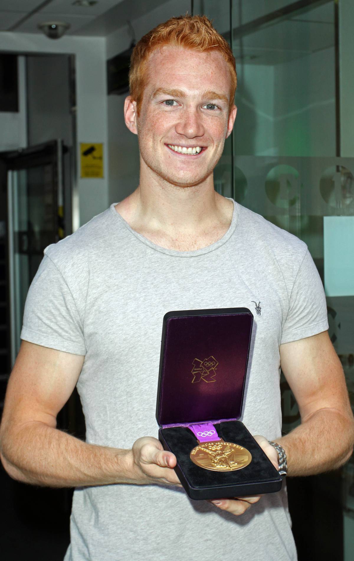 Greg Rutherford shows off his gold medal