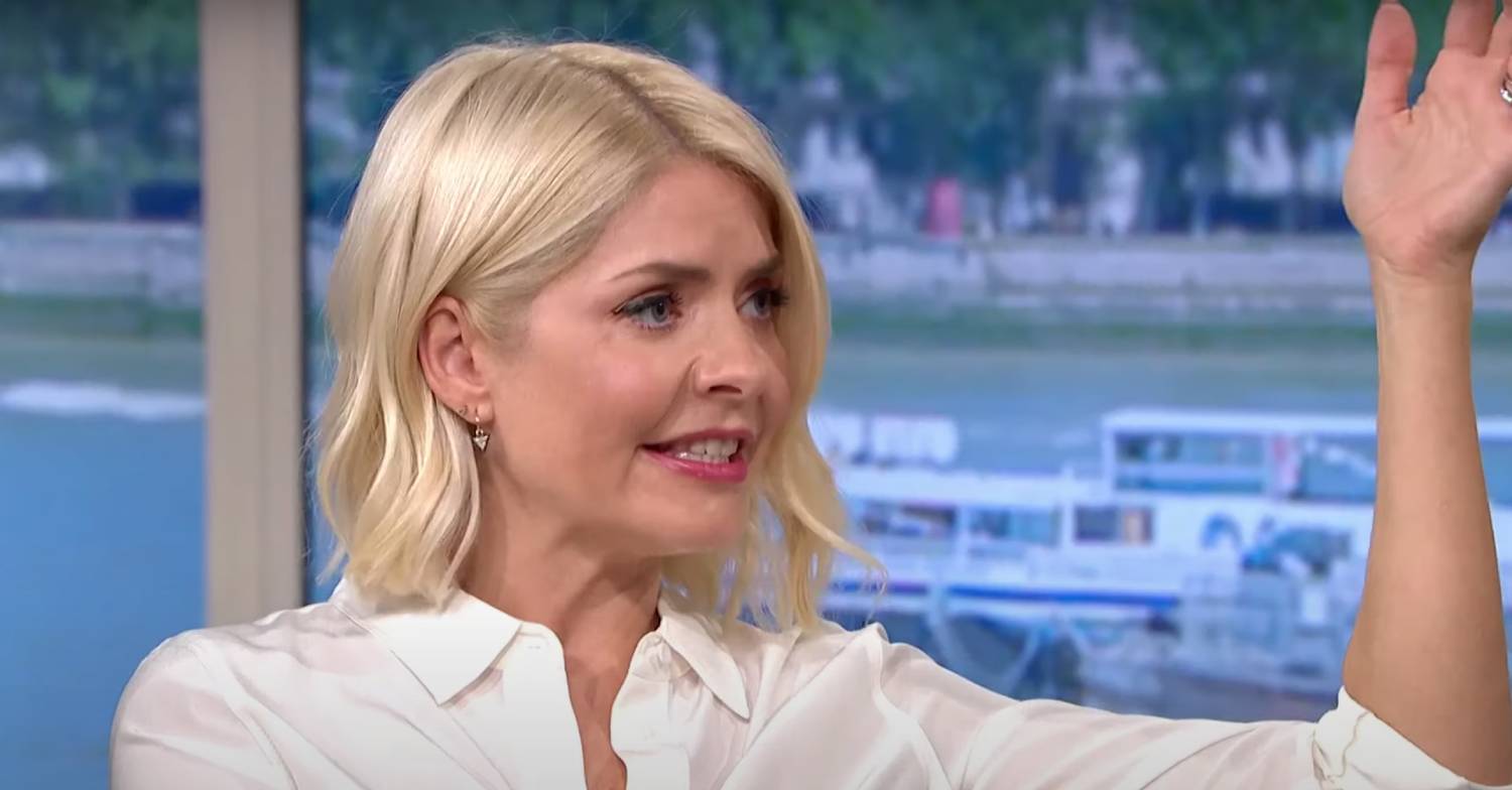 Holly Willoughby raises her hand while she speaks
