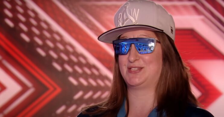 Honey G wearing a cap and sun glasses at her X Factor audition