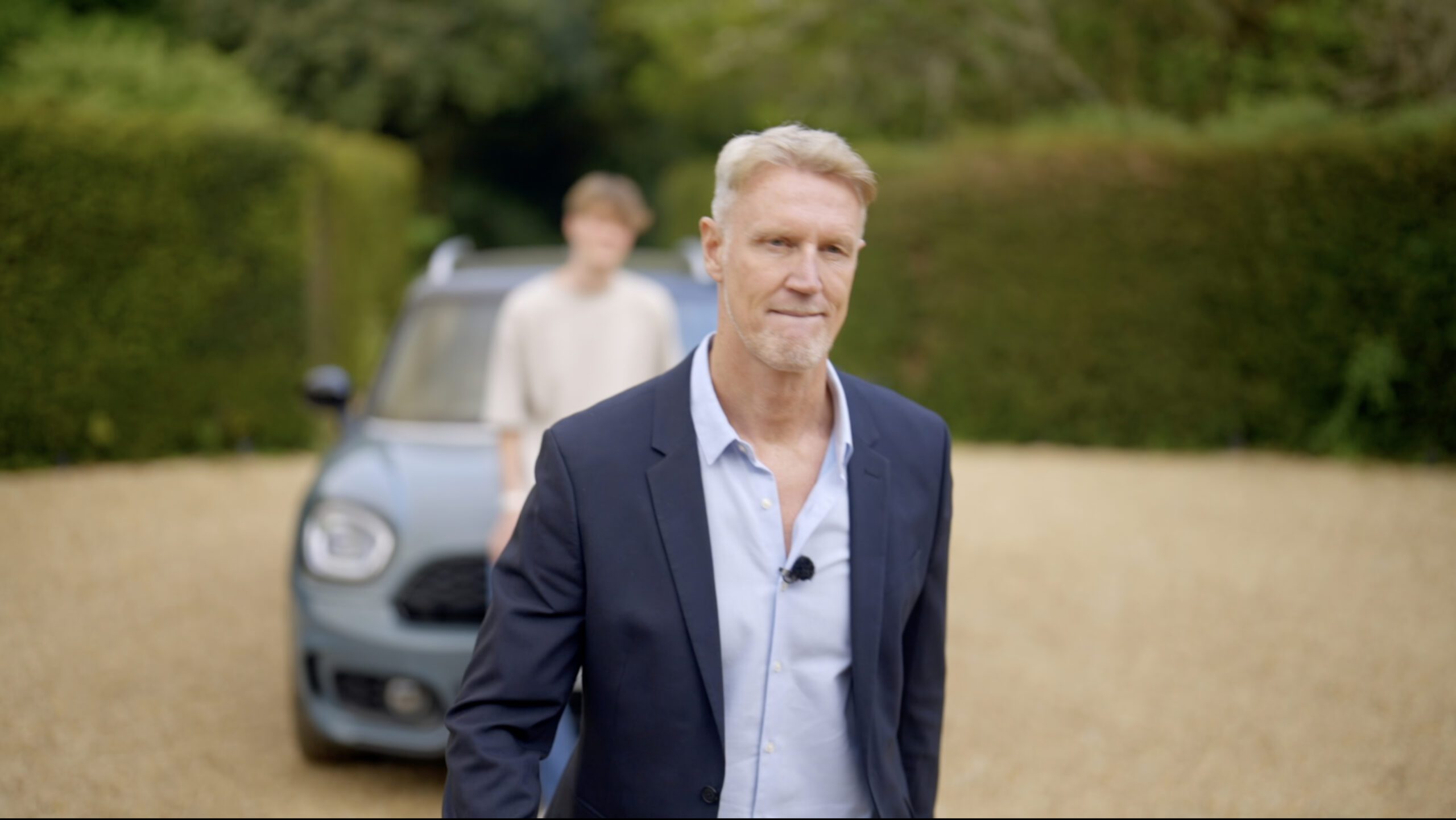 Martin H grinning in front of his car and son
