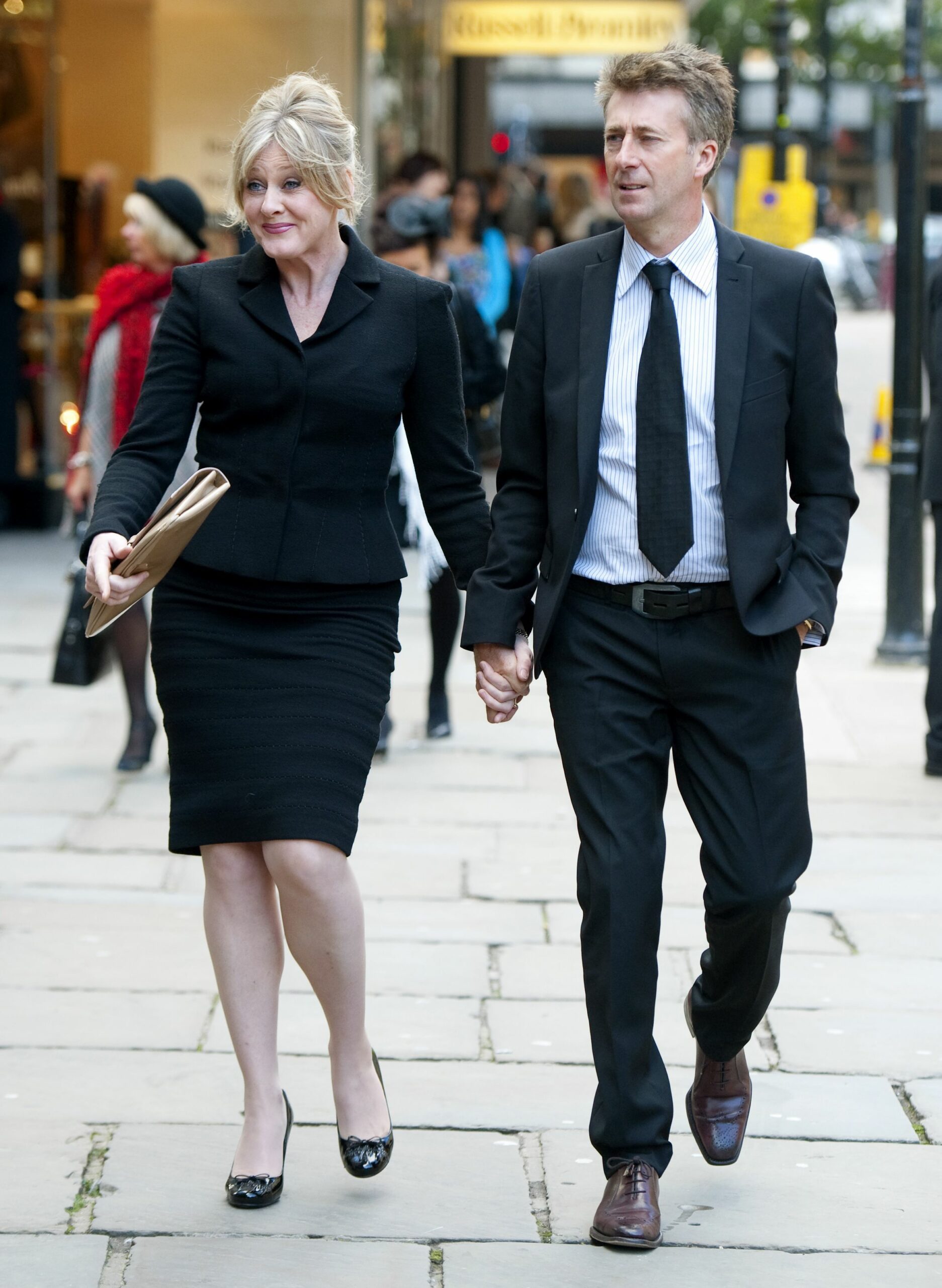 Sarah Lancashire holding hands with her husband