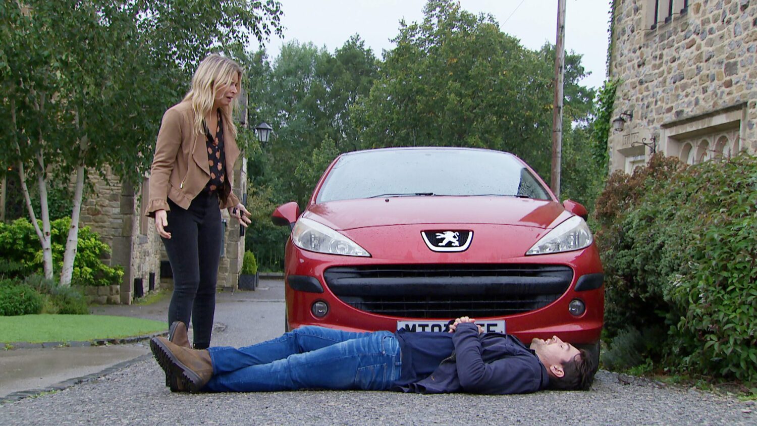 Emmerdale's Mack is lying down on the road in front of Charity's car