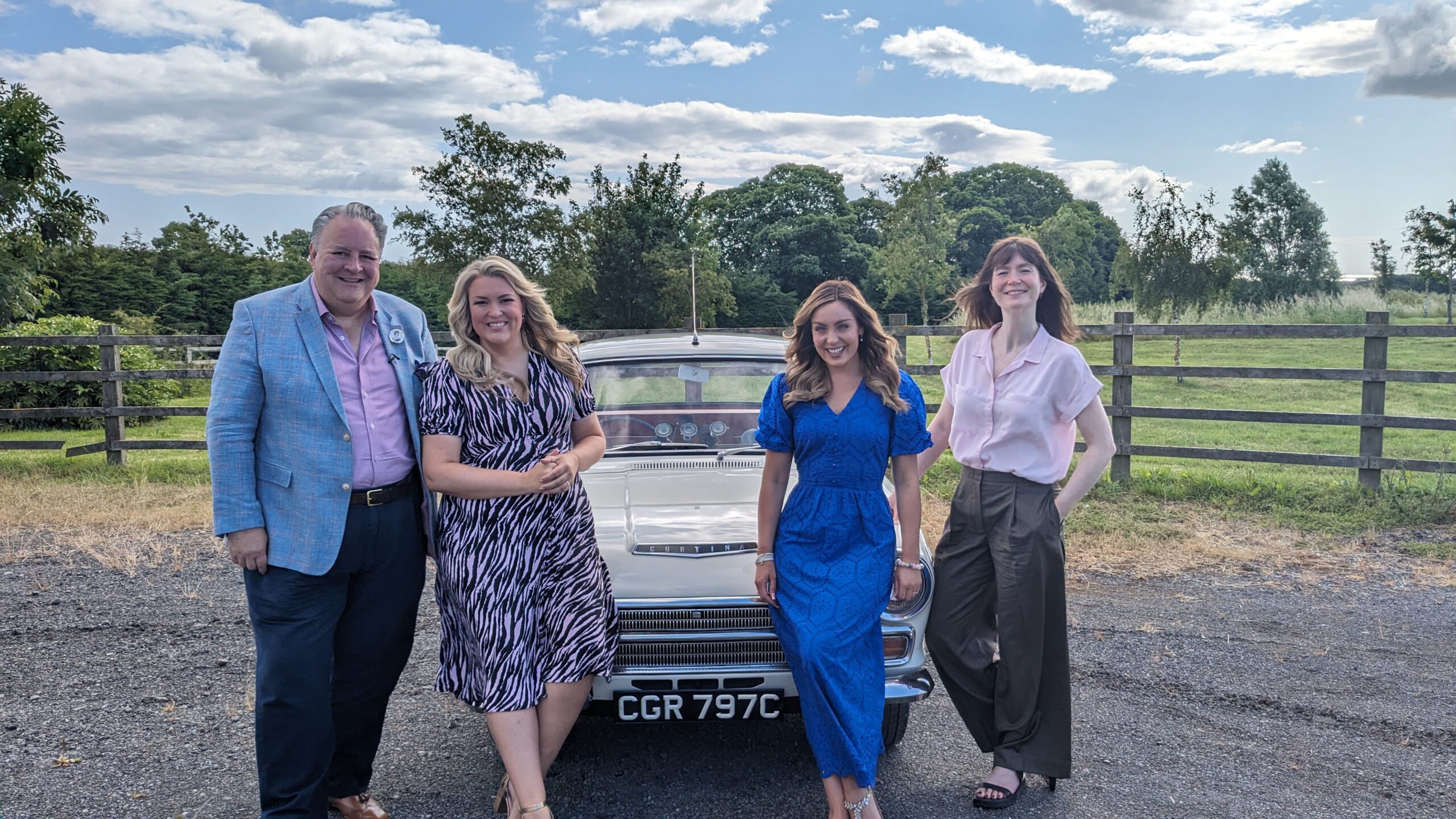 Amy Dowden sitting on a car in Antiques Road Trip