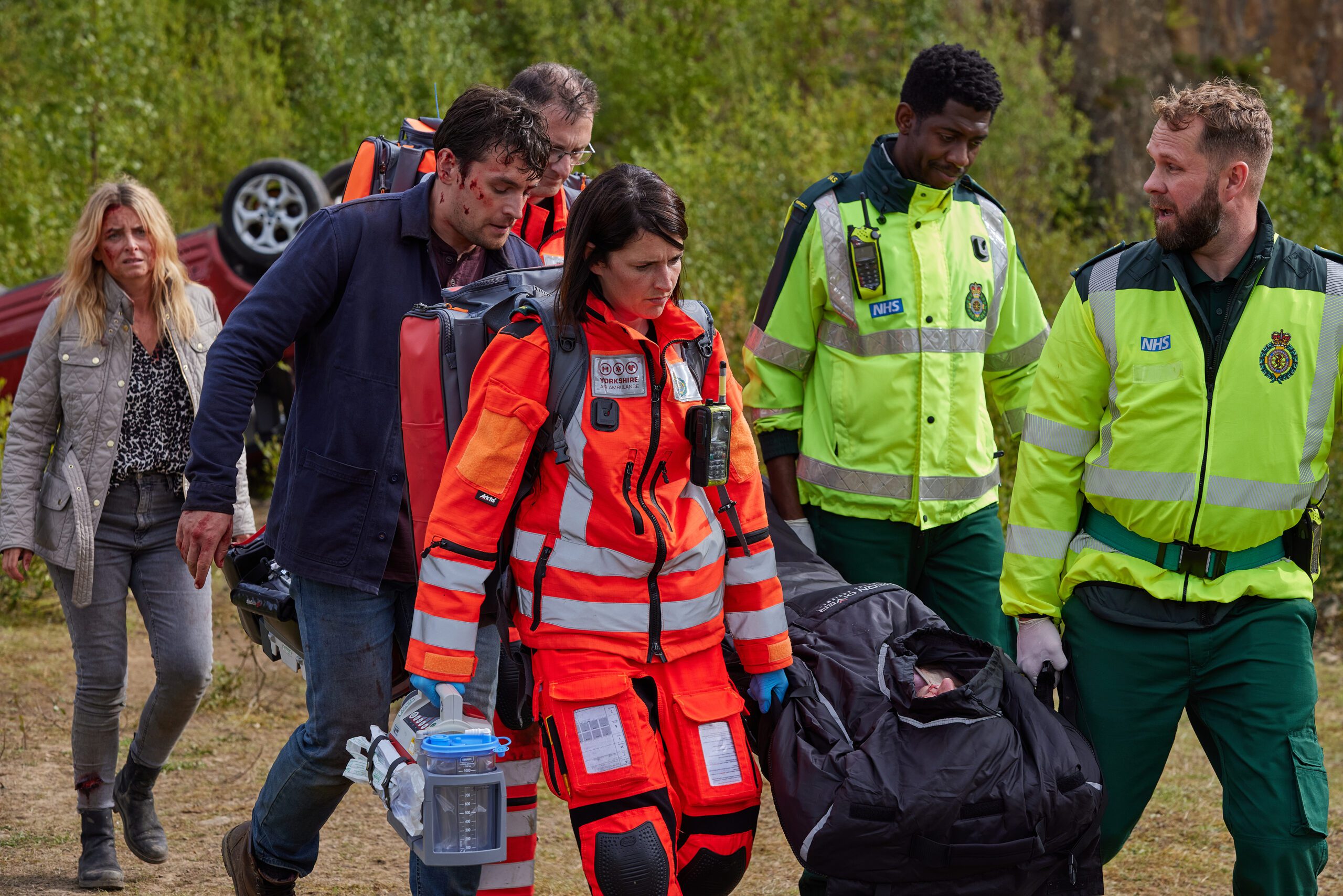 Charity and Mack are with the paramedics as Chloe is stretchered away