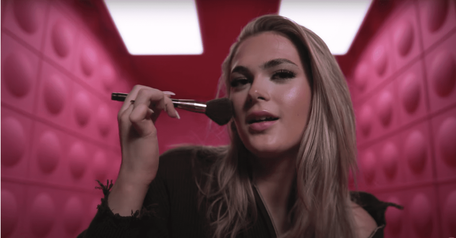 Big Brother contestant Hallie applying make up in a video ident for the show