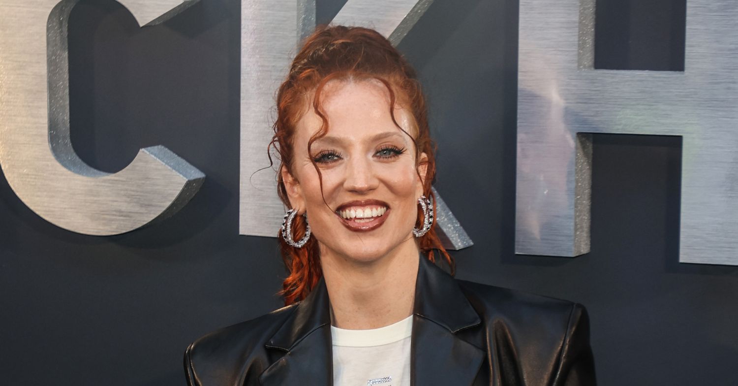 Jess Glynne smiling on the red carpet