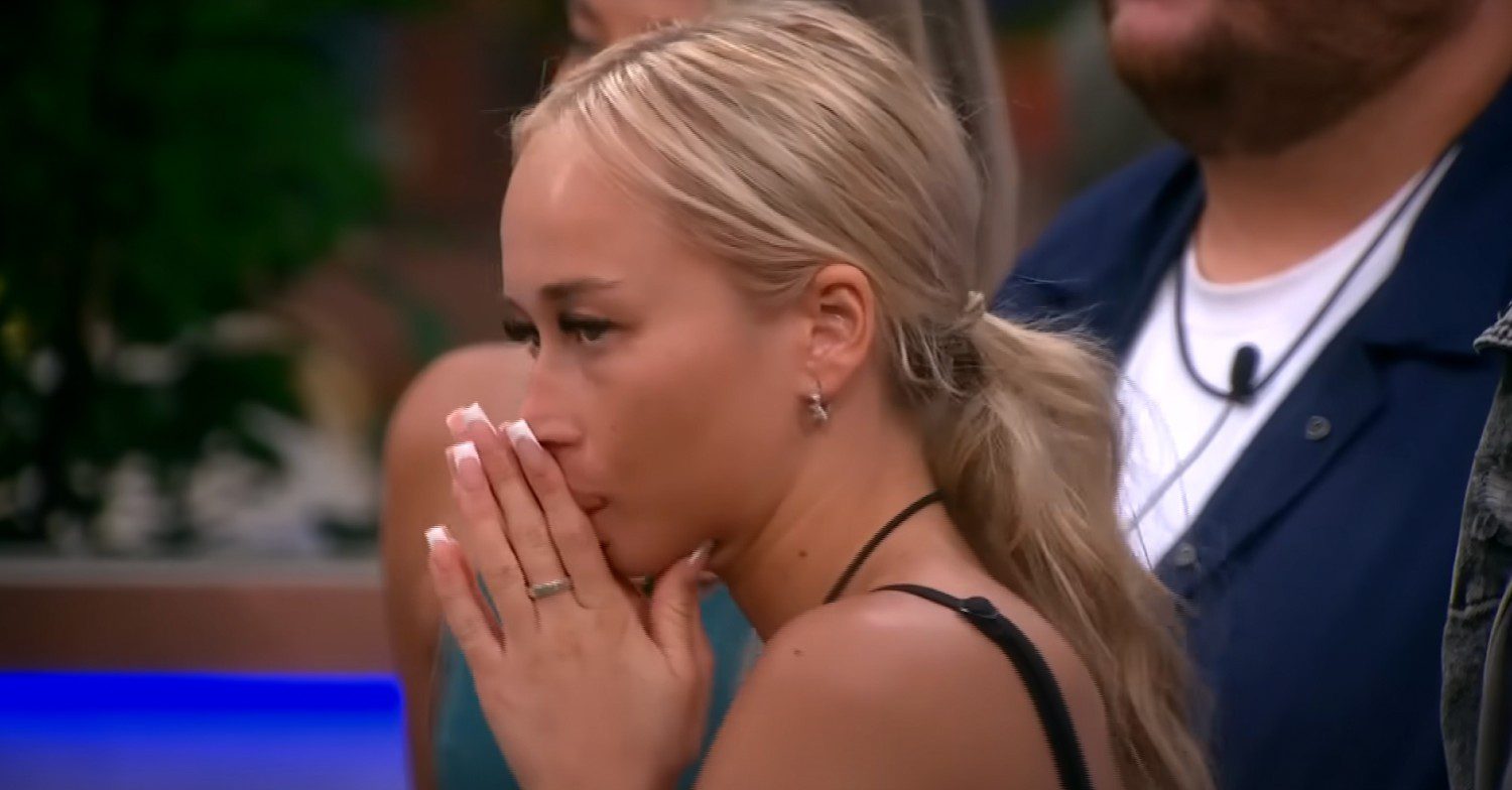 Big Brother contestant Olivia with her hands up to her mouth looking shocked