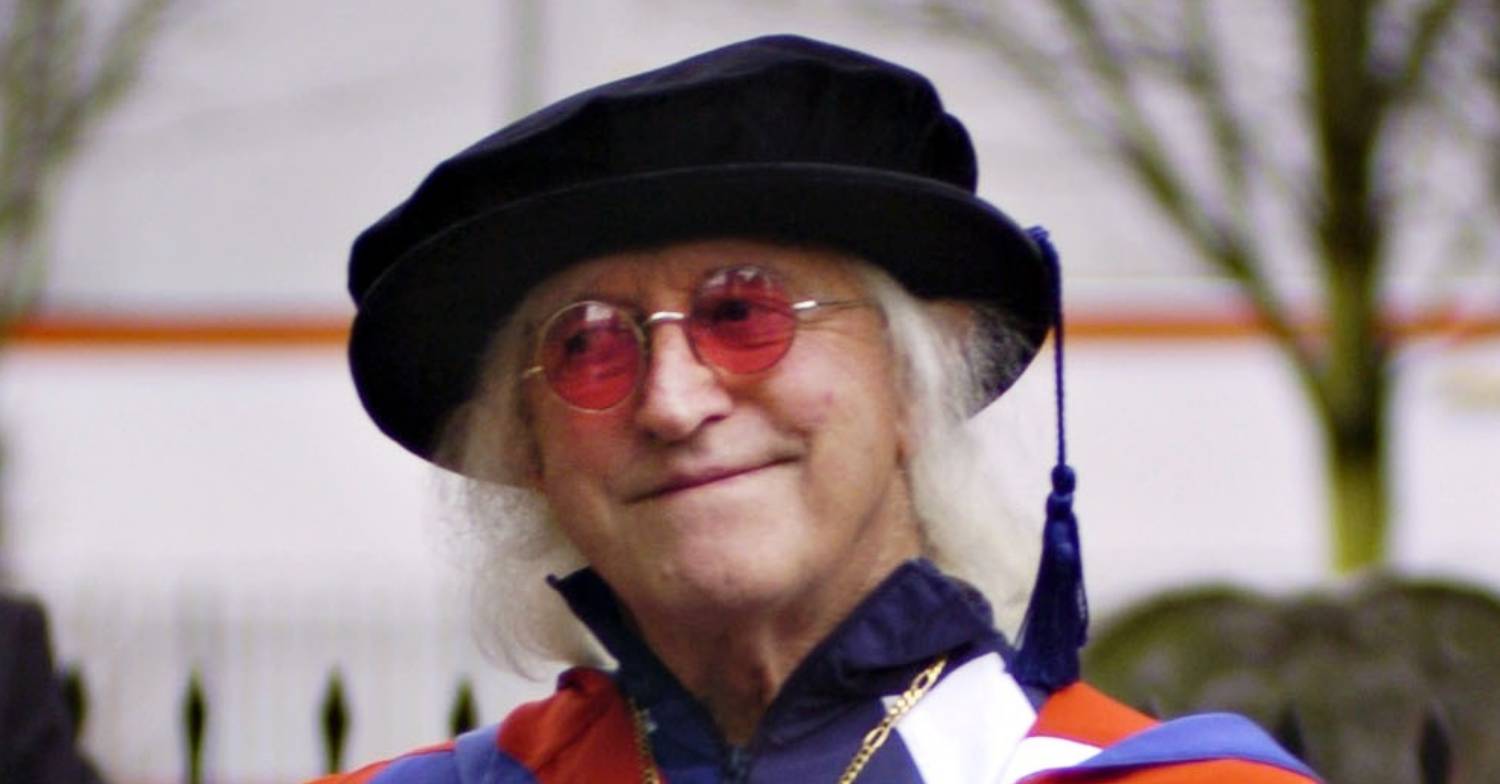 Jimmy Savile looks to the side