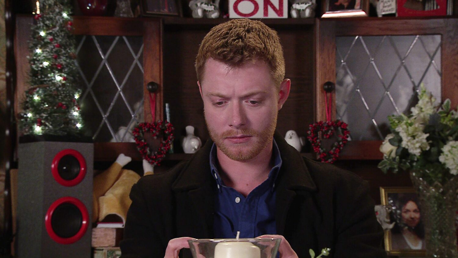 Daniel watches a video on his phone on Corrie