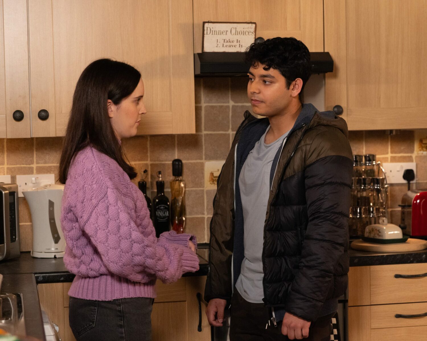 Amy and Aadi are talking in the kitchen