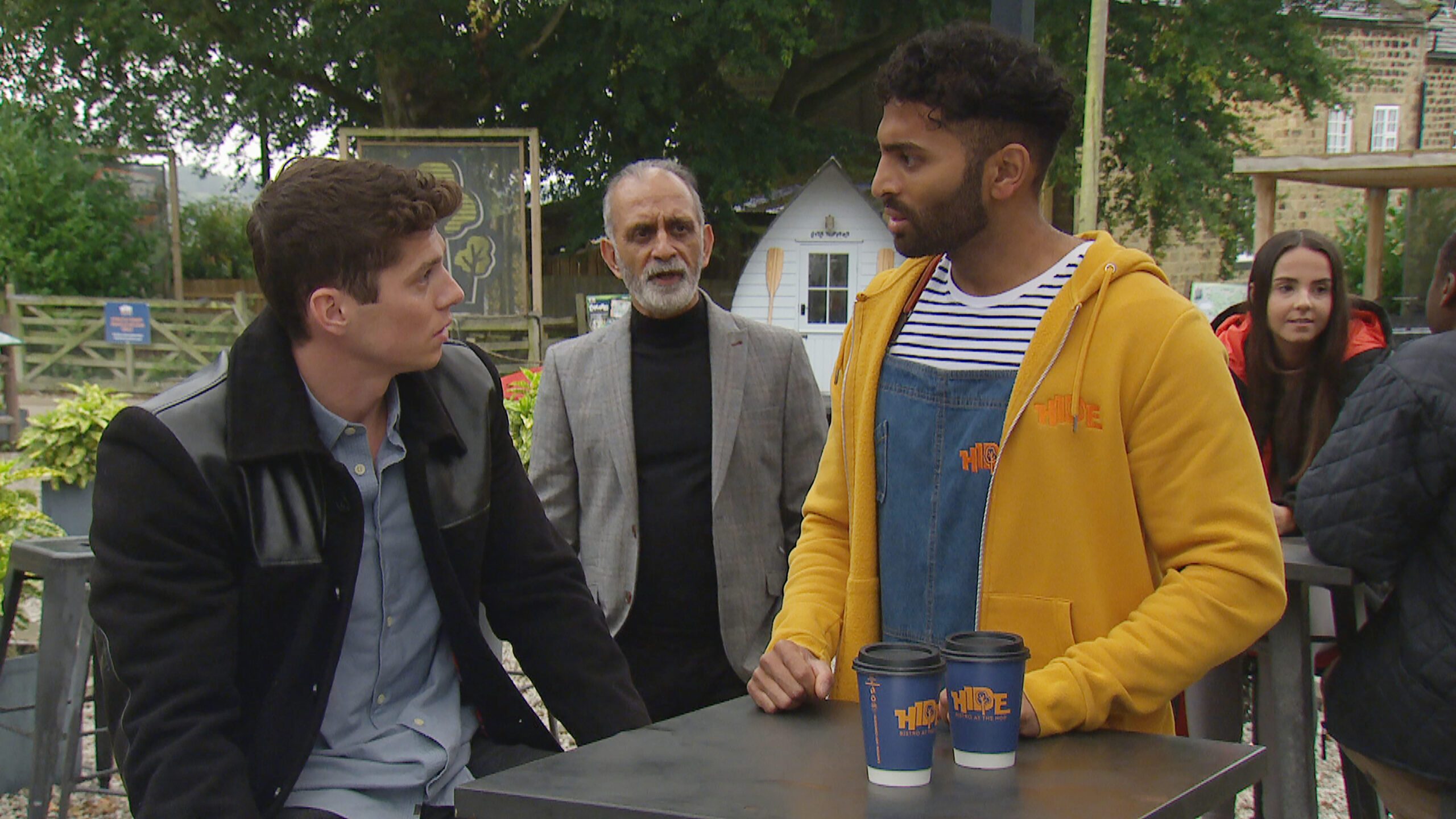 Emmerdale's Nicky, Suni and Amit are talking to each other at The Hide