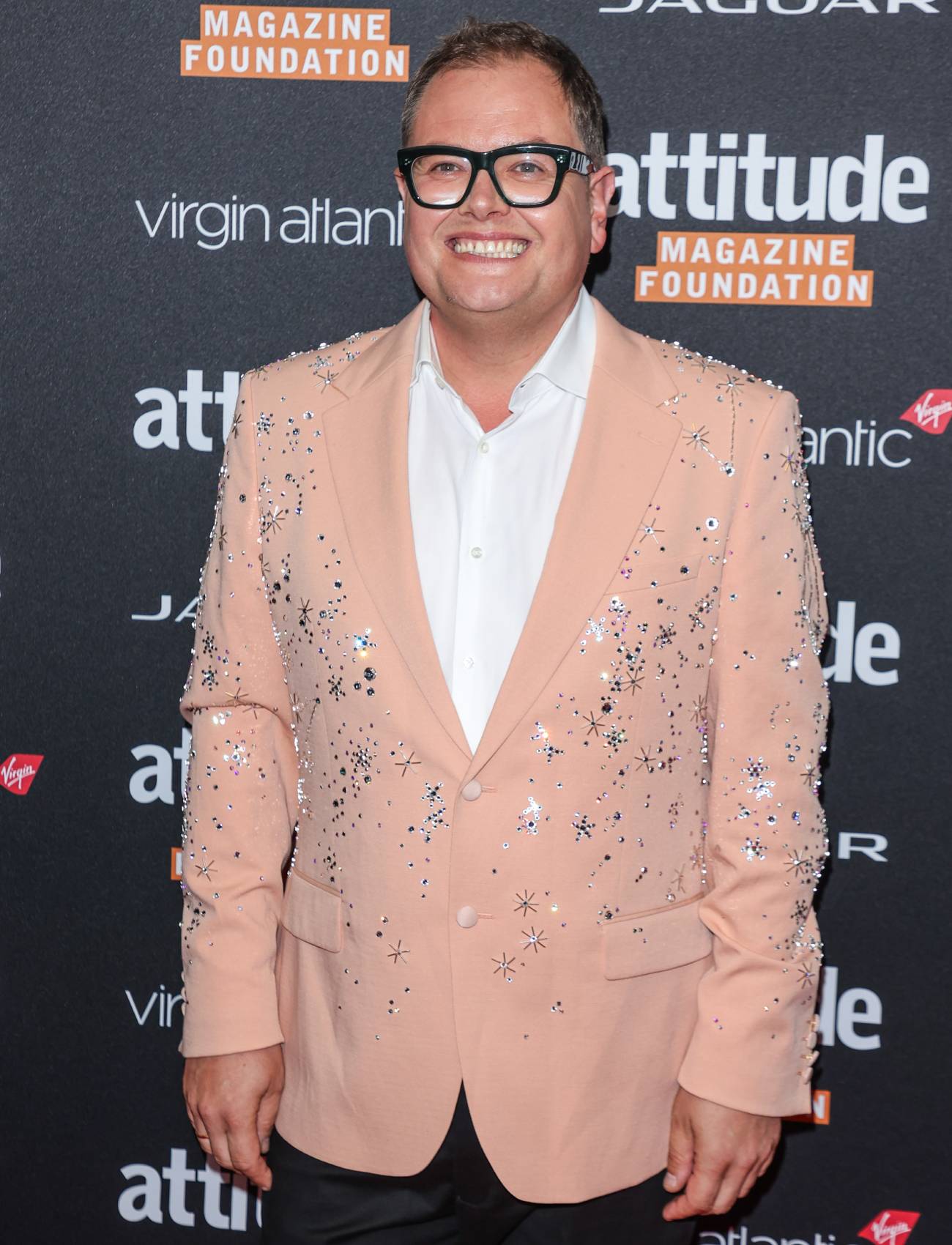 Alan Carr smiles