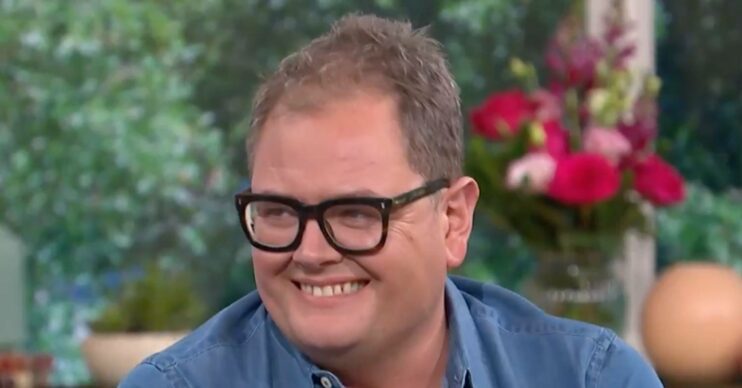Alan Carr smiles