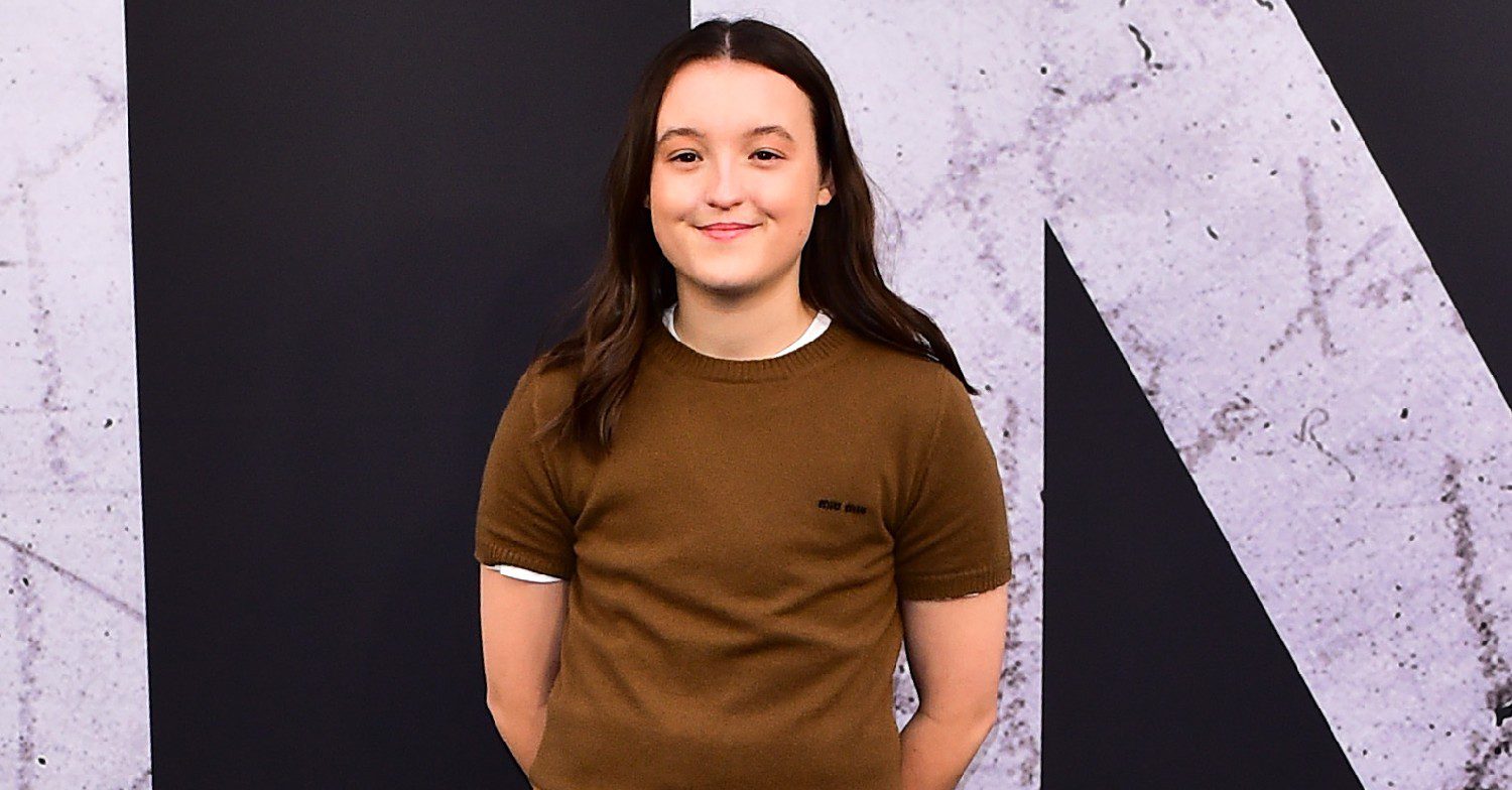 Actor Bella Ramsey standing and smiling at a press event