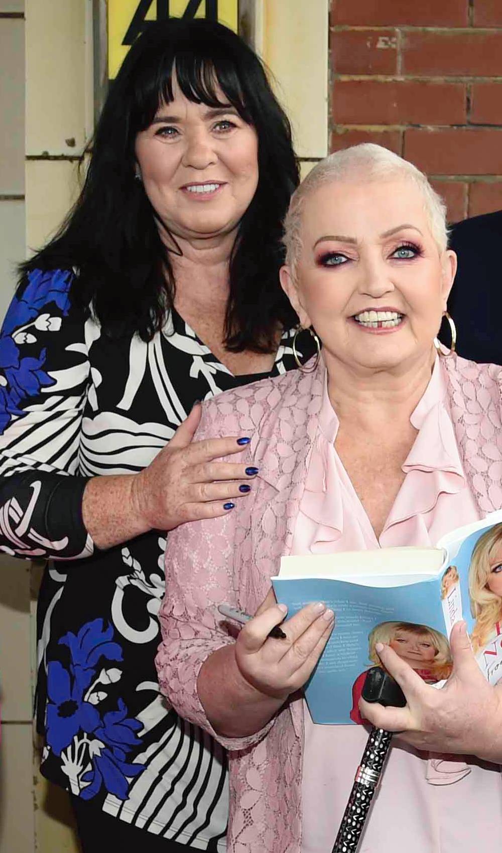 Linda Nolan smiles alongside sister Coleen Nolan