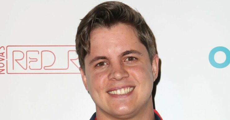 Johnny Ruffo smiling on the red carpet