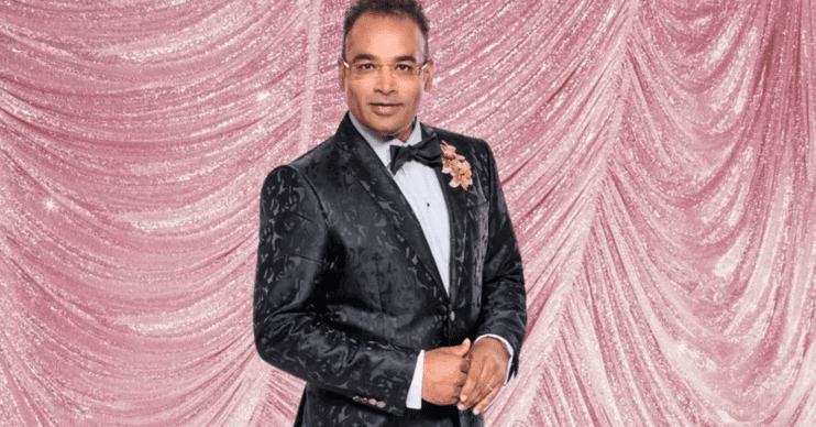 Krishnan Guru-Murthy smiling on shimmery pink Strictly background