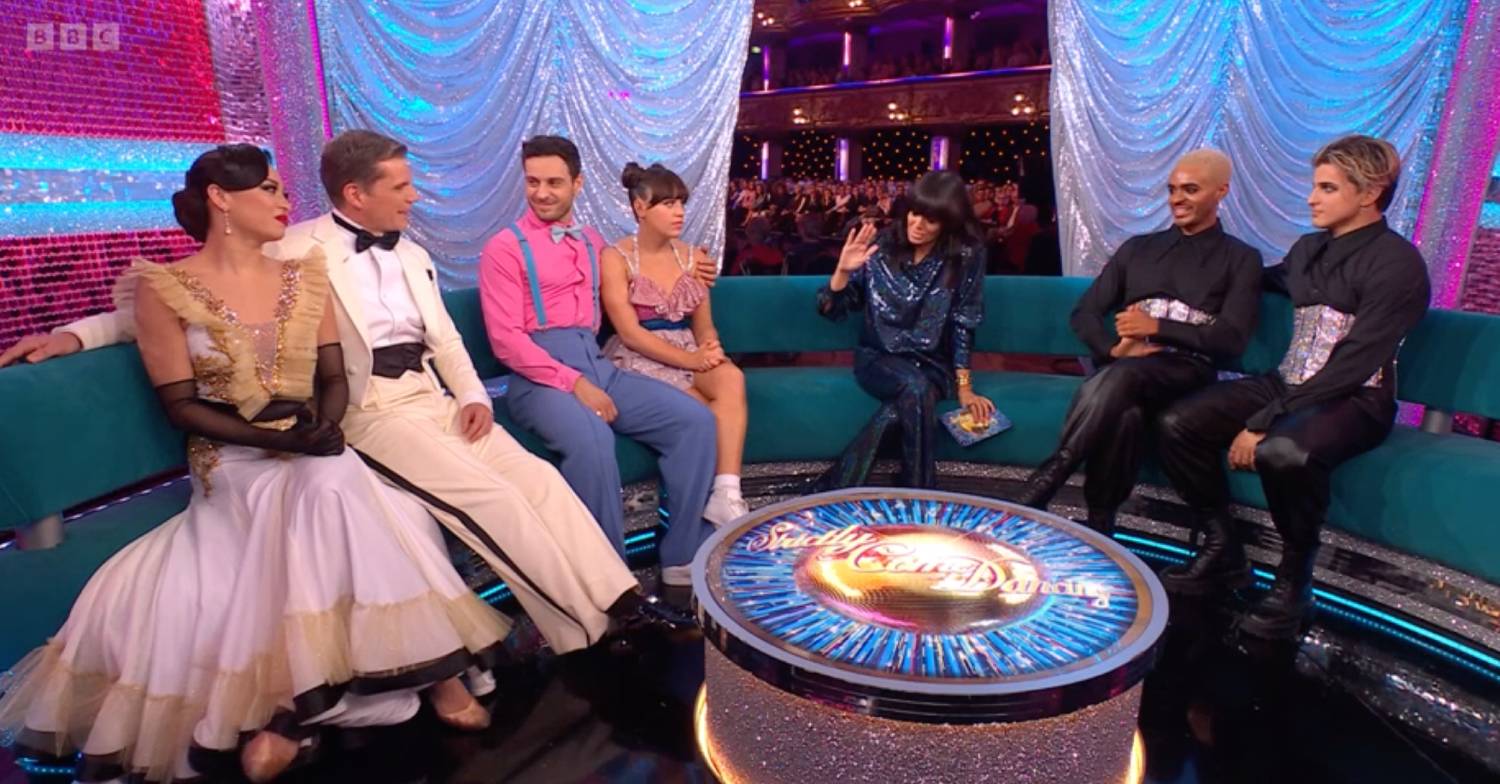 Claudia Winkleman raises a hand