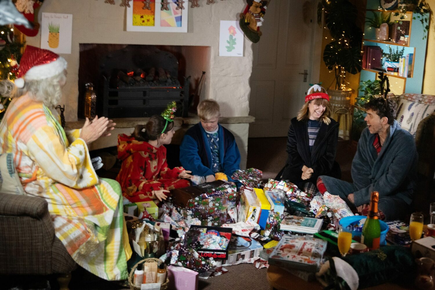 Mary, April, Leo, Rhona and Marlon open presents with joy on Christmas morning