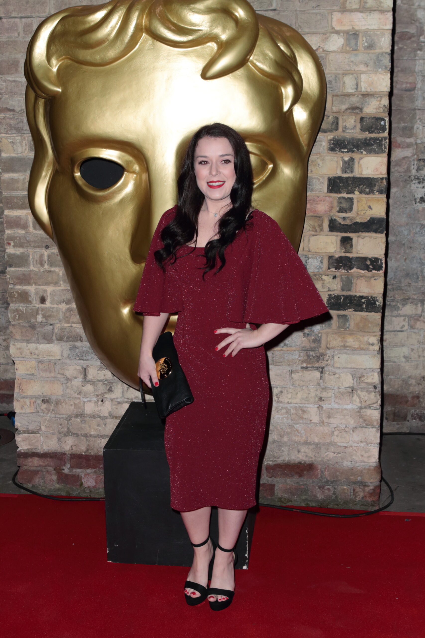 Dani Harmer posing on the red carpet