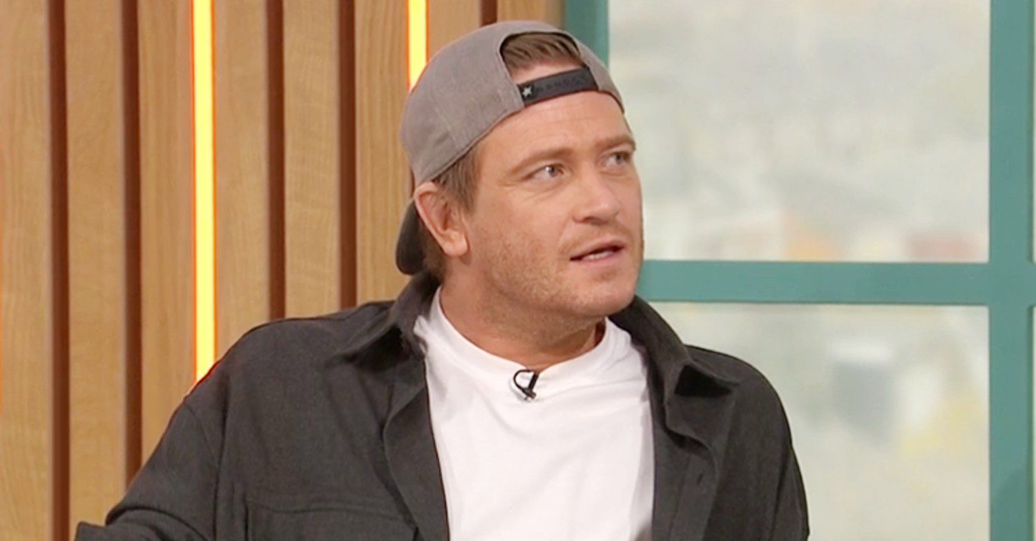 Matthew Wolfenden talking on Sunday Brunch wearing a cap (Credit: C4/Composite: ED!)