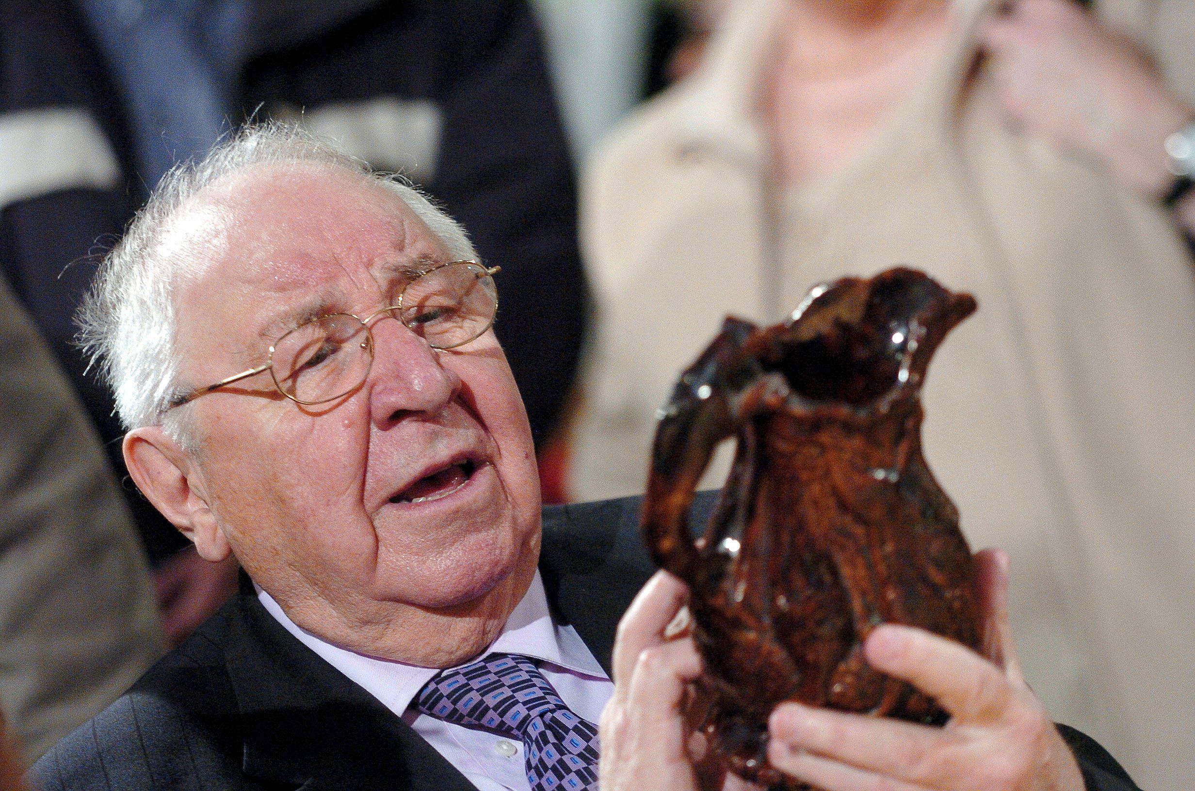 Henry Sandon on Antiques Roadshow looking at an ornament