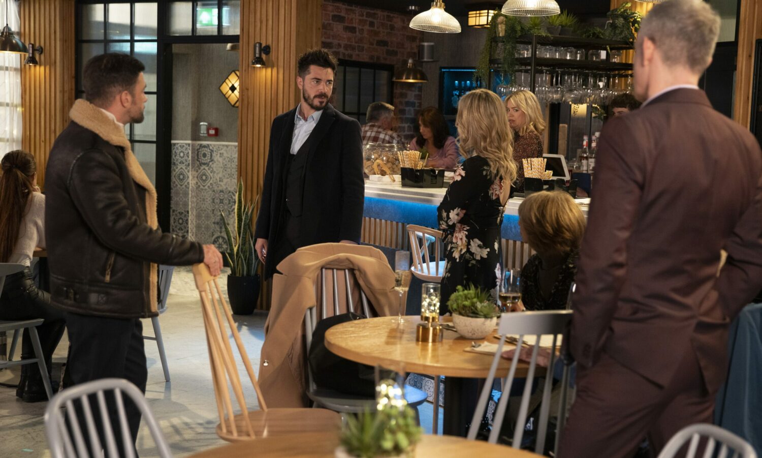 Adam storms over to where Sarah and Damon are having a drink in the bistro