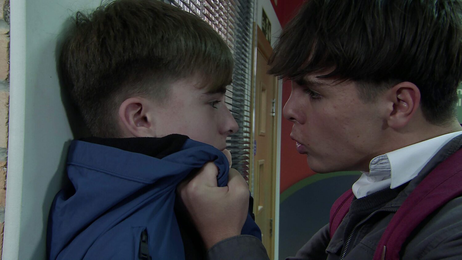 Mason pins Liam against a wall on Corrie
