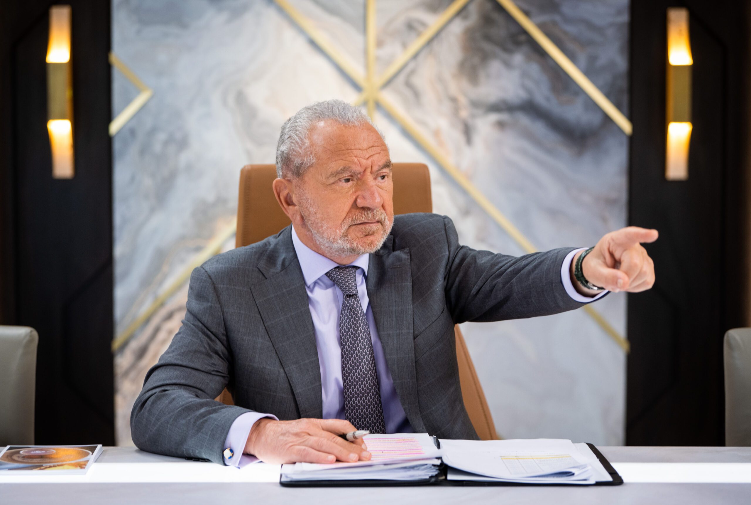 Lord Alan Sugar pointing his finger as he fires a candidate