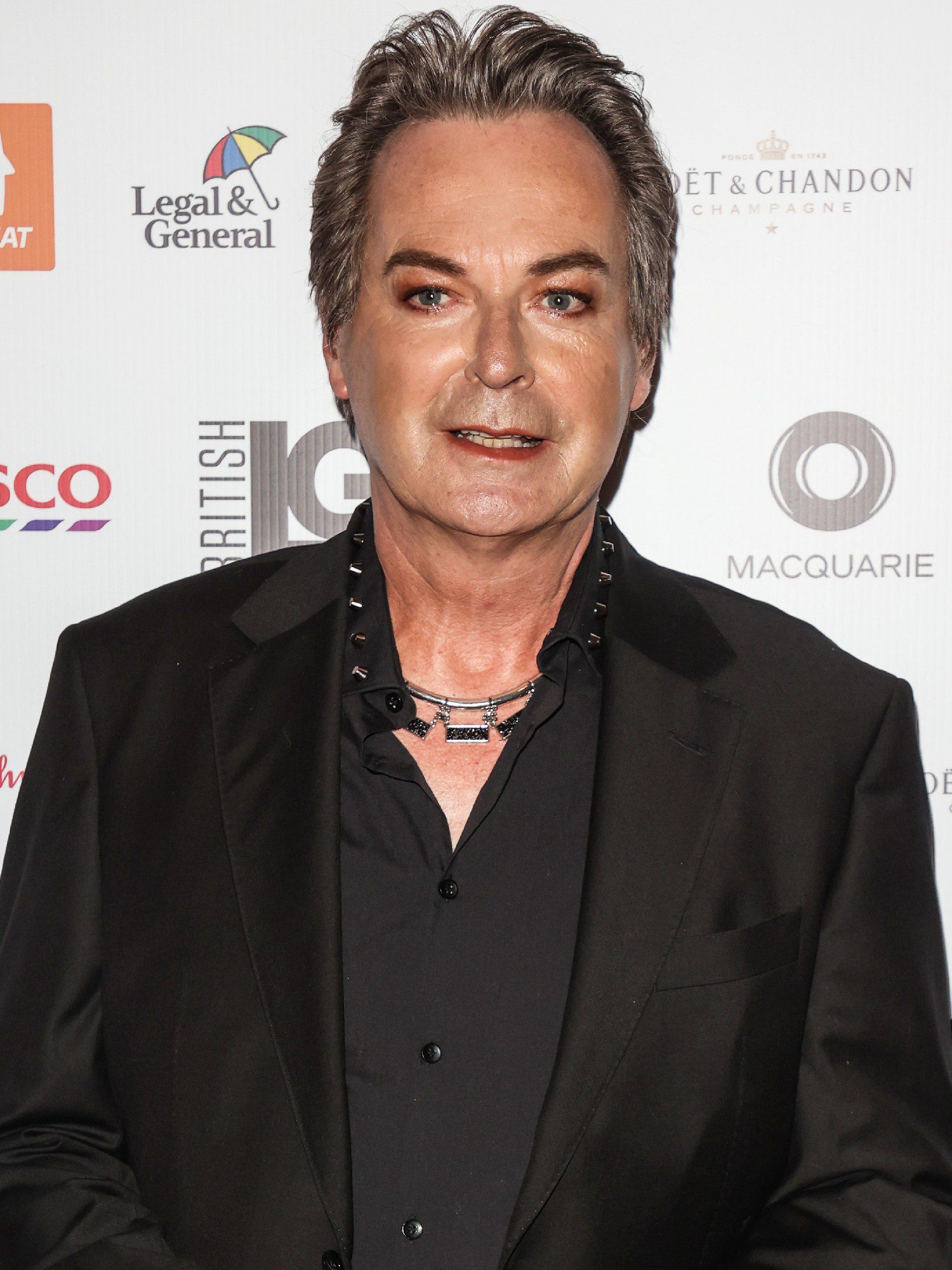 Julian Clary smiling at event