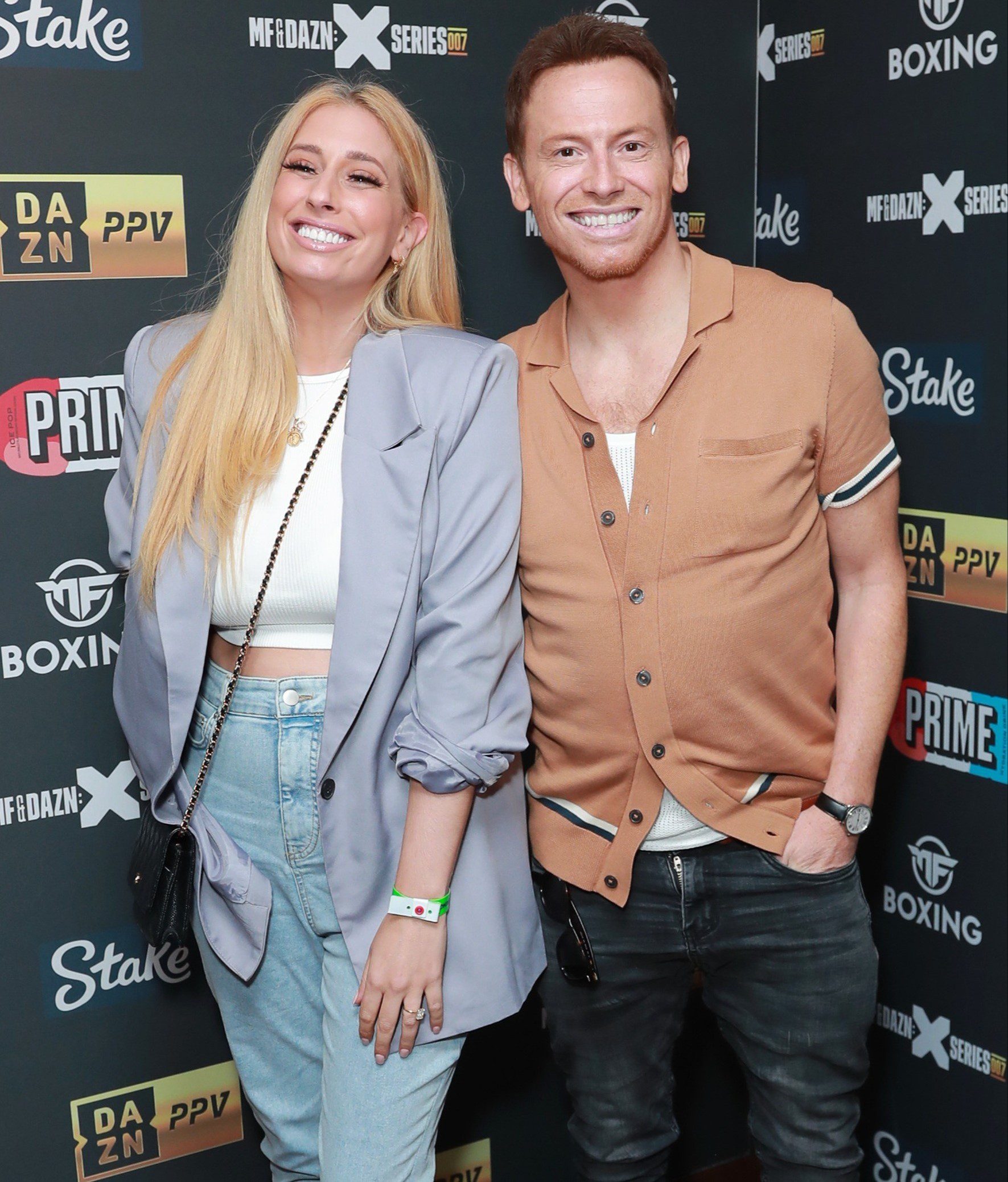 Stacey Solomon and Joe Swash smiling at event